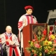 Photo of Deputy District Attorney Garret Wong giving a speech on stage during his law school graduation.