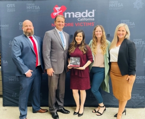 Photo of DUI Homicide Unit with Deputy DA Edith Flores receiving "Prosecutor of the Year" Award by MADD.