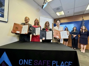 District Attorney Summer Stephan stands with the Consulate General of Mexico Alicia Kerber-Palma, Attorney General of Baja California Maria Elena Andrade, the Director of Baja California Justice Center for Women Magdalena Bautista, all holding up the signed MOUs.