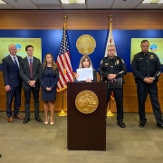 During a news conference,DA Summer Stephan holds up the Tax Form used by gang members accused of COVID Tax Fraud.