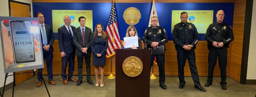 During a news conference,DA Summer Stephan holds up the Tax Form used by gang members accused of COVID Tax Fraud.