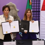 Photo of Ambassador Alicia Kerber Palma and District Attorney Summer Stephan holding MOU after the MOU signature cermeony.