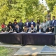 Photo of Tribal Chairpersons, DA, Sheriff Announcing Missing and Murdered Indigenous Persons Collaborative; They are all sitting at a table outside in front of an indigenous statue to Sign MOU in Sacramento.