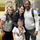 Photo of Child Abduction Unit team with recovered child at airport reunited with mother.