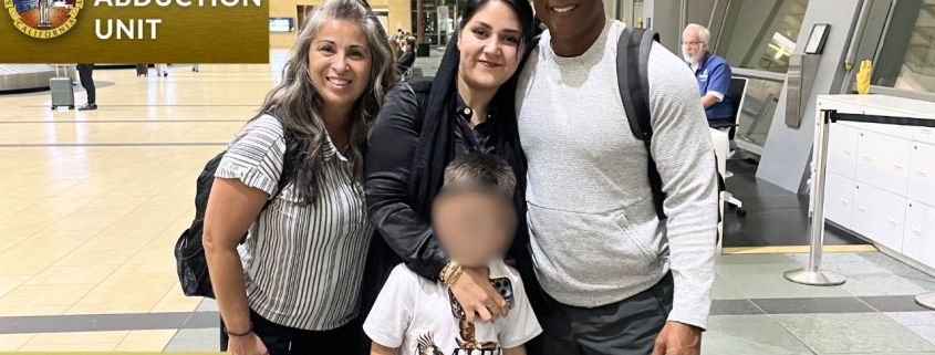 Photo of Child Abduction Unit team with recovered child at airport reunited with mother.