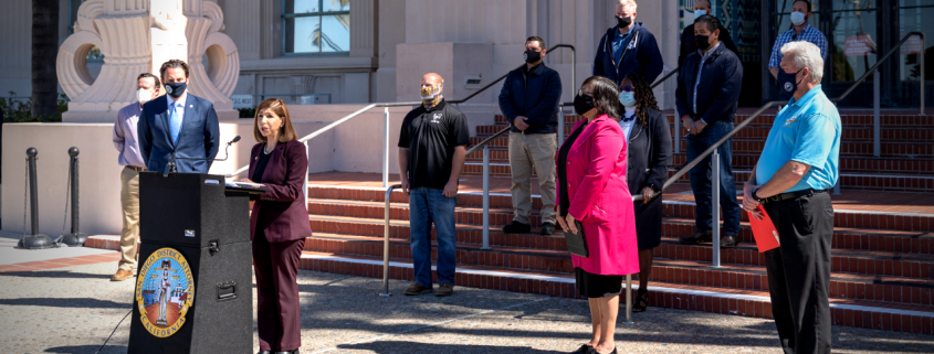 Photo of District Attorney Summer Stephan at a press conference in front of the County building.
